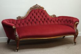 Victorian walnut camel back settee, serpentine seat, carved scrolls,