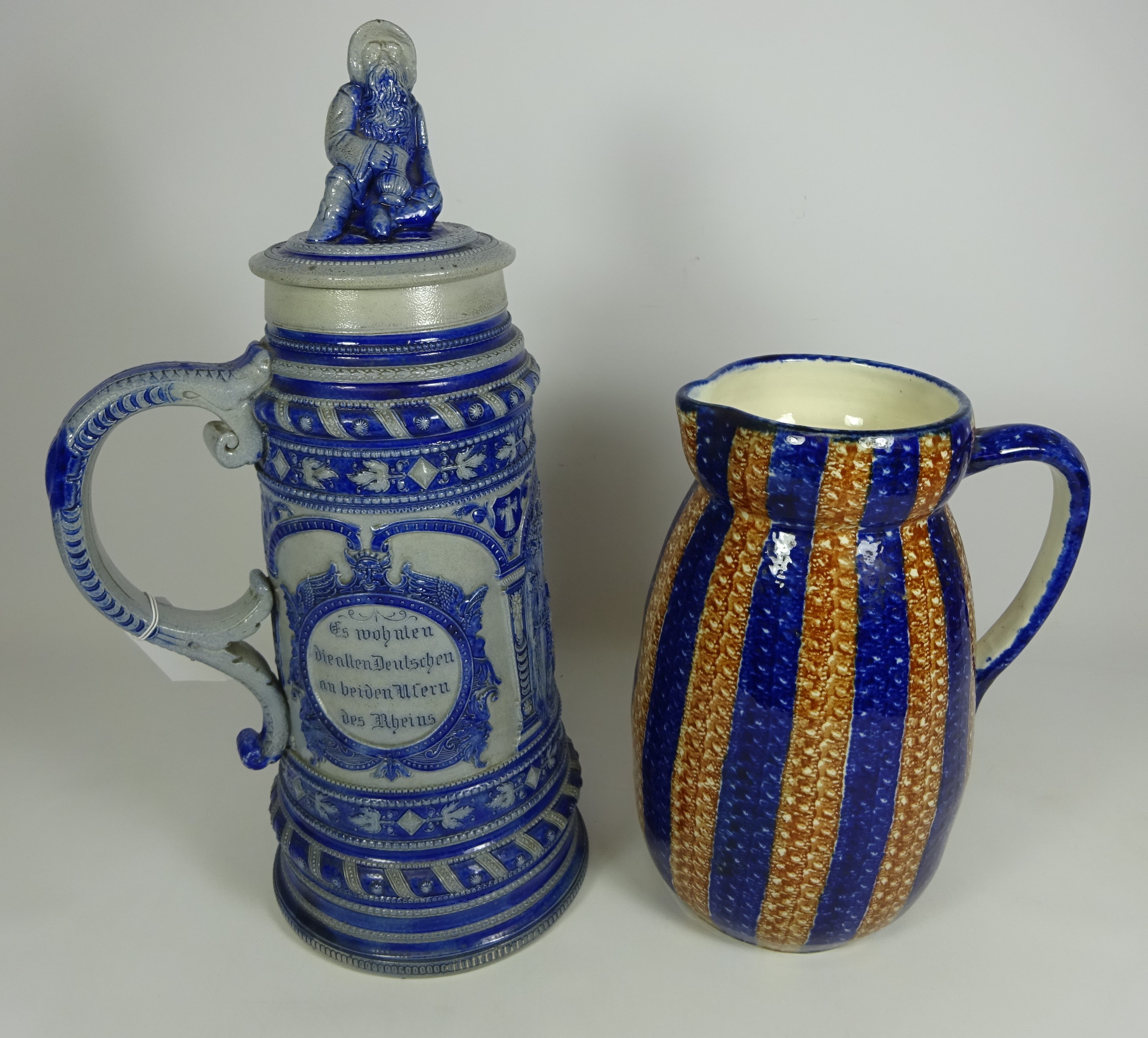 Large German stoneware beer stein H41cm with figural lid and a stoneware pottery jug H