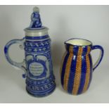 Large German stoneware beer stein H41cm with figural lid and a stoneware pottery jug H