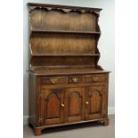 Medium oak three drawer dresser with three panelled cupboards and raised plate rack, W122cm, H182cm,