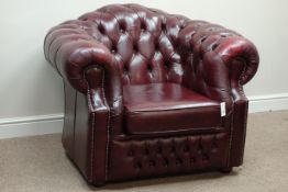 Chesterfield armchair upholstered in burgundy deeply studded leather,