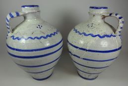 Pair of blue & white glazed ceramic decorative jugs,