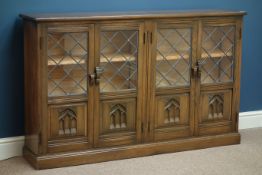 Medium oak bookcase, four lead glazed doors, W141cm, H87cm,