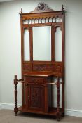 Reproduction carved mahogany hall stand, cupboard and single drawer, with bevelled mirror back,