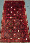 Persian red and blue ground rug, repeating motif design,