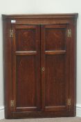 George III oak corner cabinet, two panelled doors, with three shaped front shelves, W72cm,