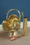 Brass coal scuttle and a fire iron with brass artillery shell case stand Condition