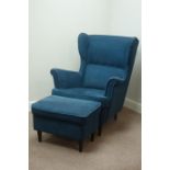 Modern Strandmon wing back armchair upholstered in dark blue fabric and matching footstool