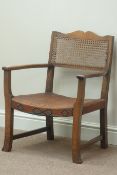 20th century oak armchair with cane back and leather upholstered seat with stud work frieze