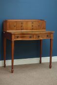 Jaycee yew wood serpentine two drawer writing desk, with six raised drawers and two cupboards,