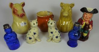 Two early 20th Century milk jugs in the form of pigs, pair of faience type cats,
