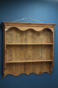 20th century pine two tier wall hanging plate rack, shaped apron, W121cm, H114cm,