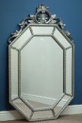 Ornate silver cushion framed mirror, bevelled glass,