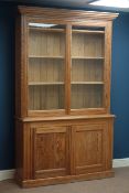 Victorian pitch pine bookcase on cupboard, two glazed doors, W136cm, H216cm,