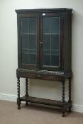 Early 20th century oak bookcase fitted with two lead glazed doors on barley twist stand, W89cm,