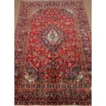 Persian Kashan red and blue ground rug carpet, stylised floral design repeated in border,