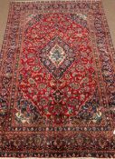 Persian Kashan red and blue ground rug carpet, stylised floral design repeated in border,