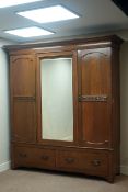 Late 19th/early 20th century Arts & Crafts wardrobe enclosed by two doors with carved detail,