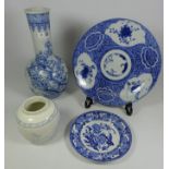 19th Century blue and white Japanese shallow dish and another Japanese bottle vase decorated with