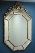 Octagonal wall mirror in gilt frame with sectional mirrored border and ornate pediment, W88cm,