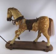 Antique pull along hide covered toy horse,