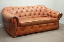 Pair two seat Chesterfield sofas upholstered in buttoned tan leather,