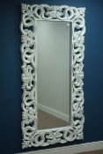 Bevelled edge wall mirror in rectangular white painted open carved frame,