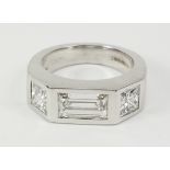 Baguette and princess cut diamond three stone white gold ring in rub over setting hallmarked 18ct,