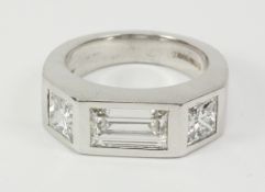 Baguette and princess cut diamond three stone white gold ring in rub over setting hallmarked 18ct,