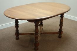 Ercol golden dawn finish elm extending dining table with foldout leaf,