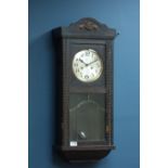 Early 20th century oak cased wall clock, twin train movement striking on the half hours,