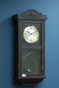 Early 20th century oak cased wall clock, twin train movement striking on the half hours,