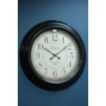 Large circular wall clock in black metal frame,