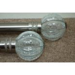 Two burnished metal curtain rails with crackled glass finials, with brackets and rings,