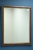 Rectangular wall mirror in brown and gilt frame,