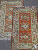 Two Turkish orange and beige ground rugs 130cm x 80cm Condition Report <a