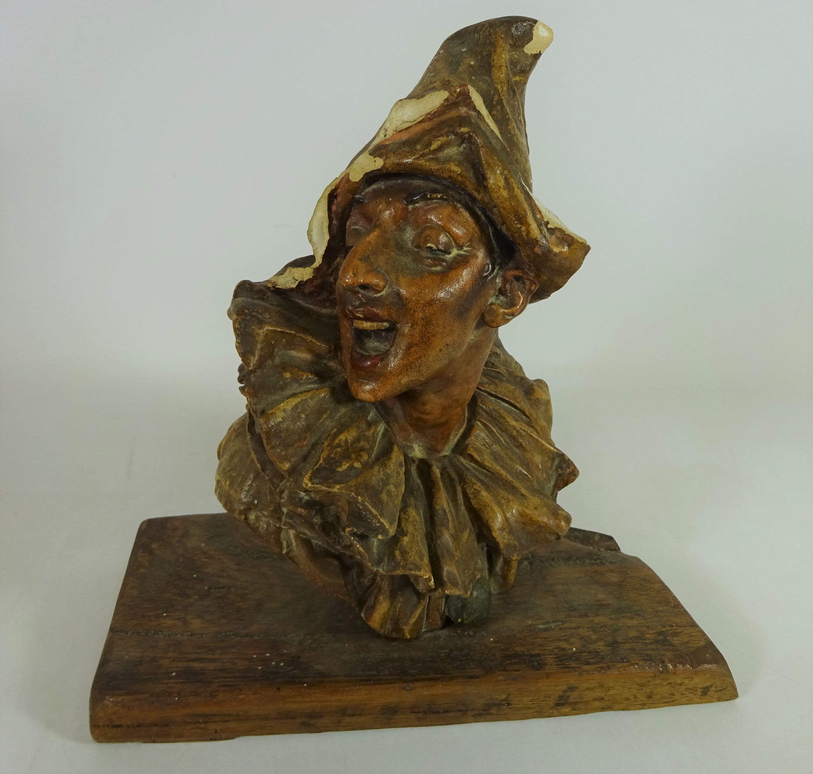 Pottery bust of a pierrot / performer signed on back G.