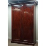 Early Victorian mahogany wardrobe two shaped arched panelled doors enclosing hanging space,