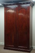 Early Victorian mahogany wardrobe two shaped arched panelled doors enclosing hanging space,