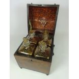 Early 19th Century four bottle figured mahogany Tantalus box,