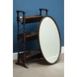 Oval oak framed wall mirror with bevelled glass and a barley twist three tier book case