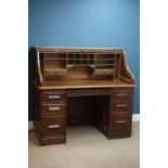 Early 20th century 'Angus London' tambour roll top twin pedestal desk, seven drawers,