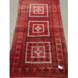 Afghan red ground rug, triple square medallion,