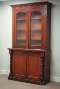 Victorian mahogany bookcase on cupboard, raised glazed doors, W113cm, H206cm,