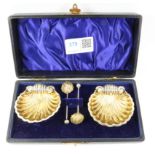 Pair of Victorian silver-gilt scallop shell salts and matching spoons cased by T H Hazlewood & Co