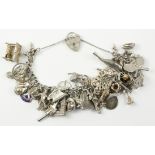 Hallmarked silver curb chain bracelet with approx 39 charms Condition Report <a
