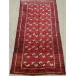 Turkoman Bokhara red ground rug, 256cm x 136cm Condition Report <a href='//www.