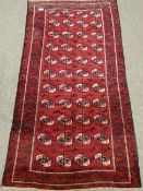 Turkoman Bokhara red ground rug, 256cm x 136cm Condition Report <a href='//www.
