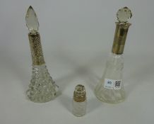 Three 19th/ early 20th Century cut glass scent bottles with hallmarked silver mounts (3)