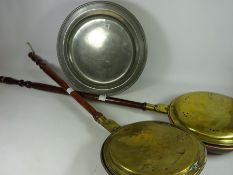 Two turned wood brass and copper warming pans and a pewter charger Condition Report